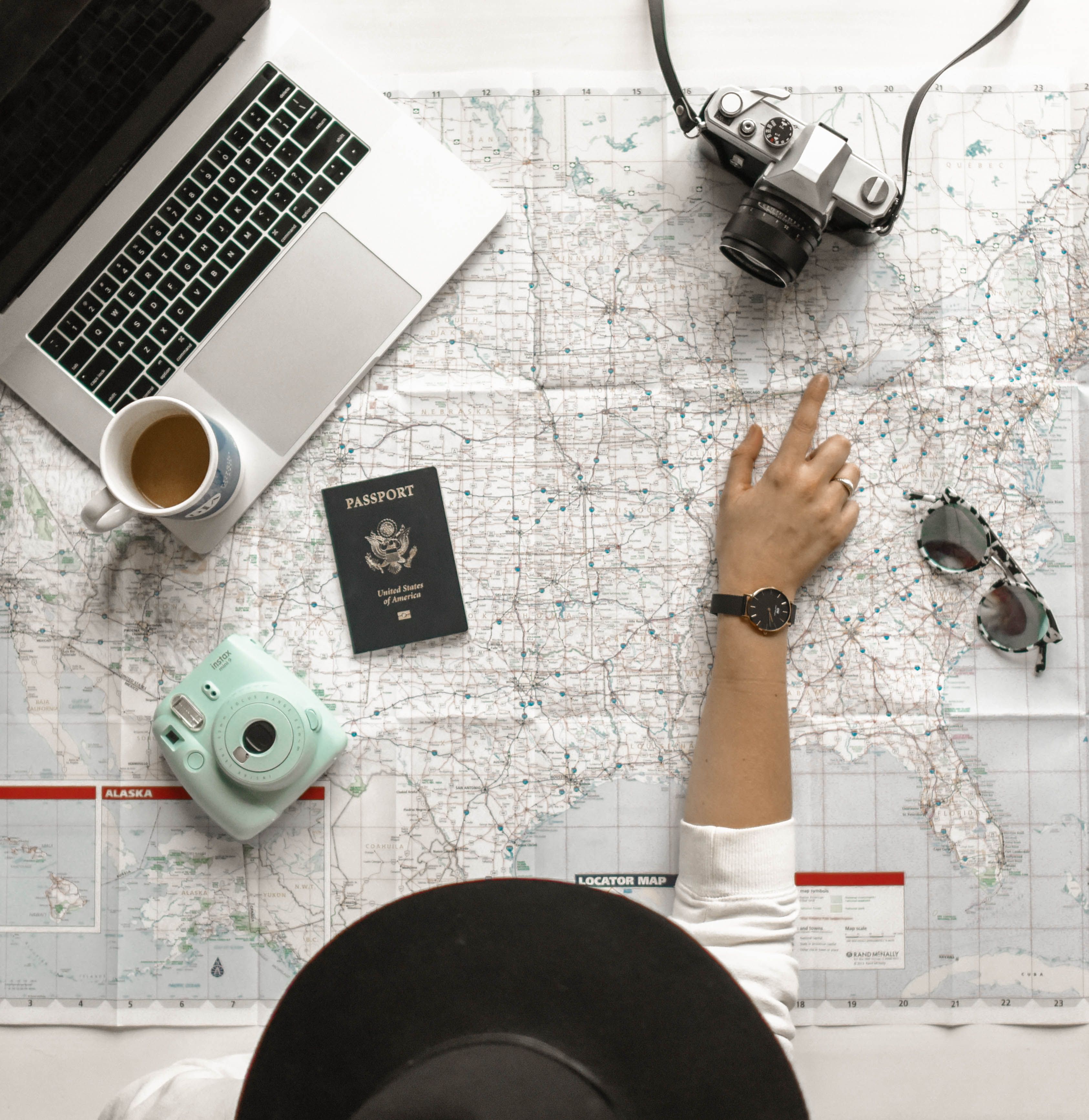 Laptop, map, and passport for travel planning support
